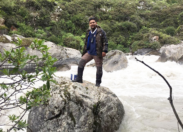 Amrit Thapa beside river, during field trip