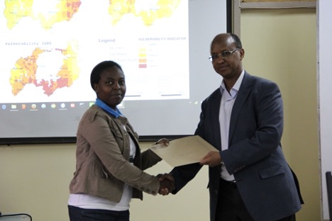 Dr. Hussein Farah presenting training certificate to participant