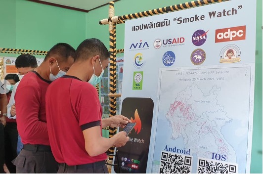 First Responders examine poster display about Smoke Watch app