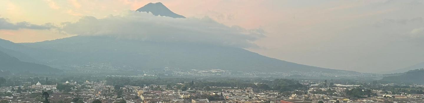 A panoramic view of Antigua, Guatemala with mountains in the background