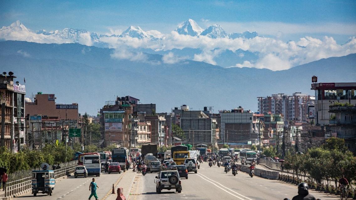 city street with mountains in background